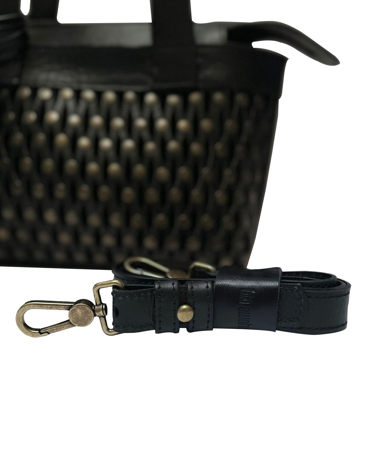 Detail of the metallic hardware and secure closure on the black Studded Mini Tulum.