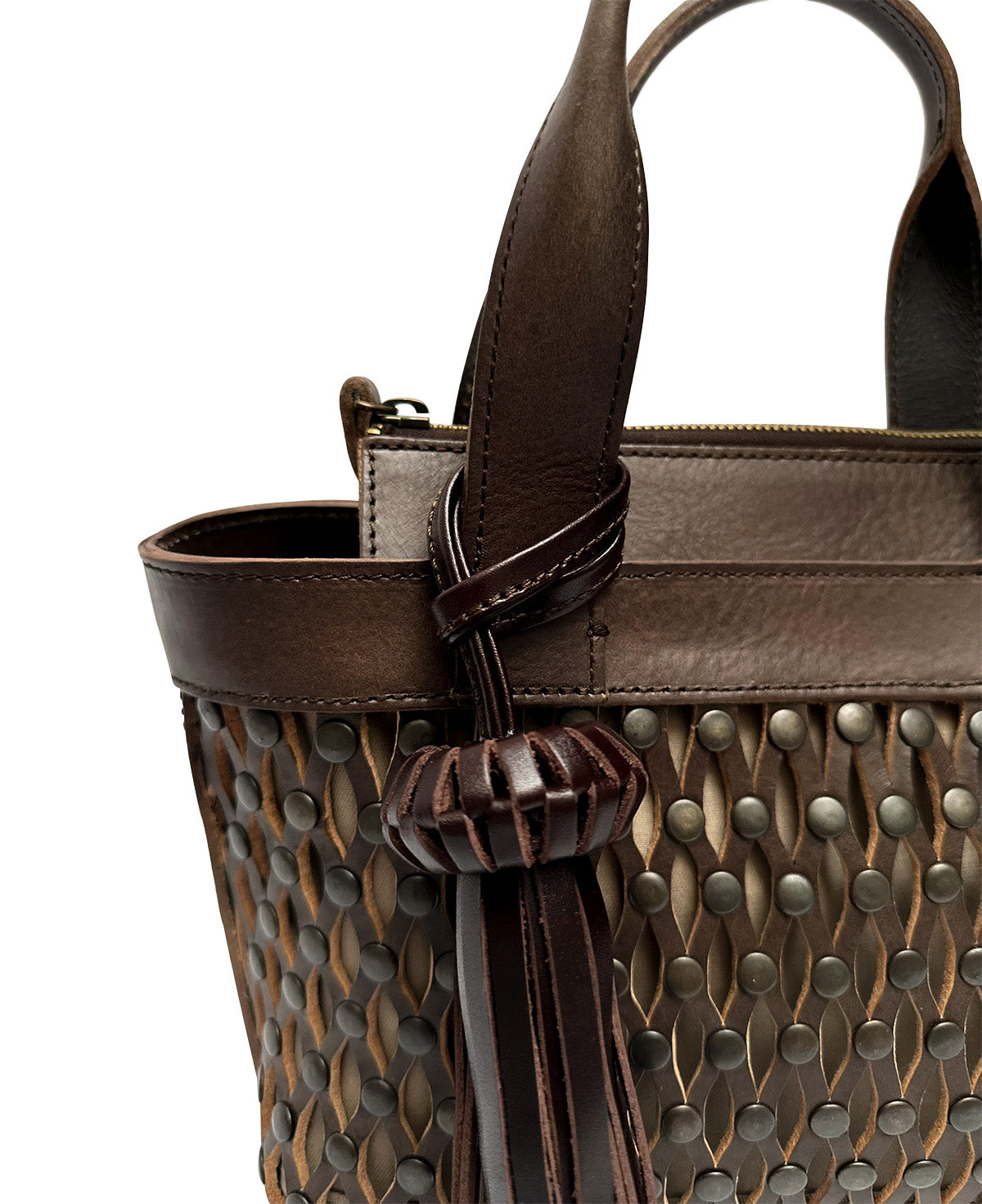 Close-up of genuine dark brown leather texture and silver metallic studs on Mini Tulum bag.