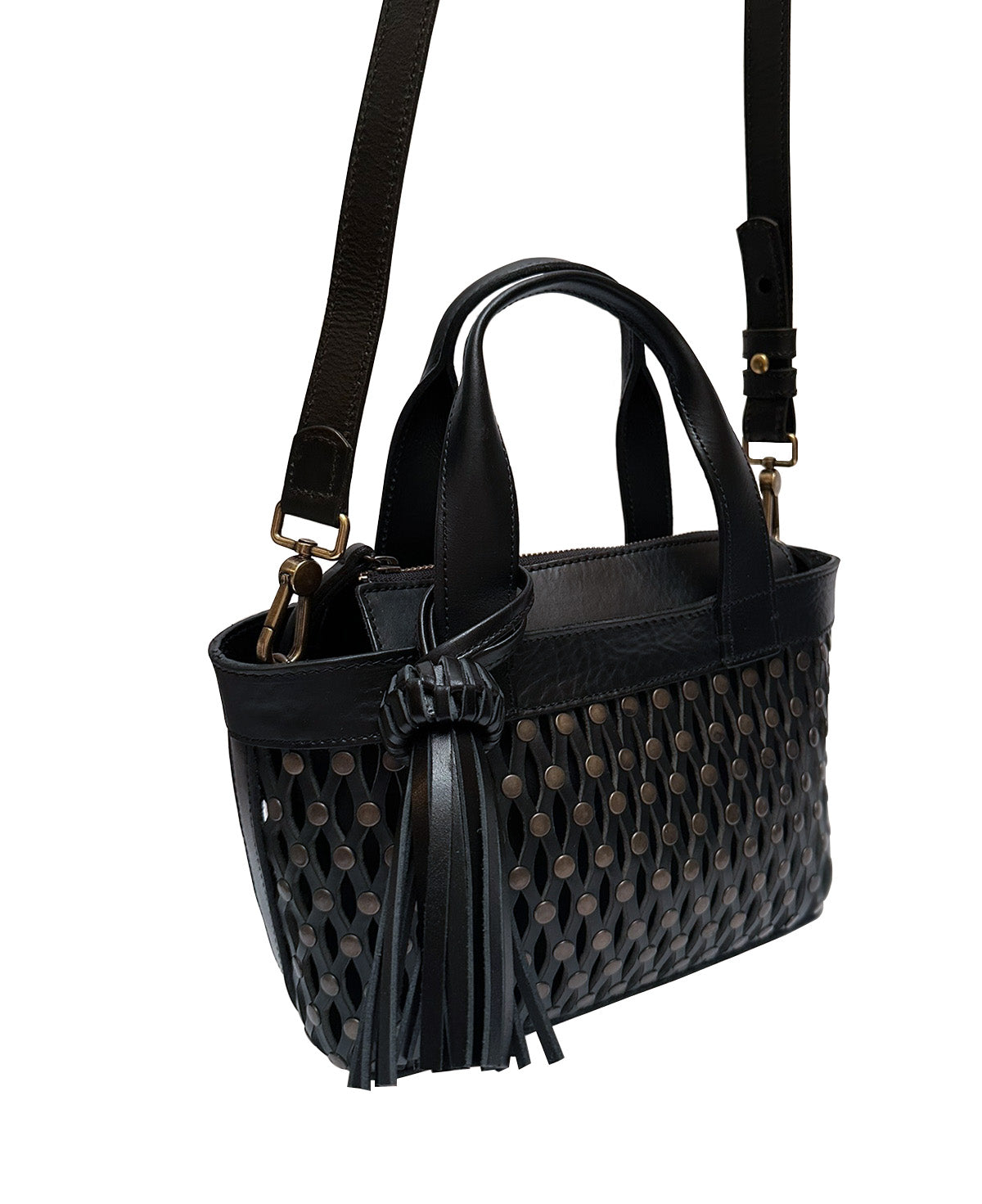 Close-up of genuine black leather texture and silver metallic studs on Mini Tulum bag.