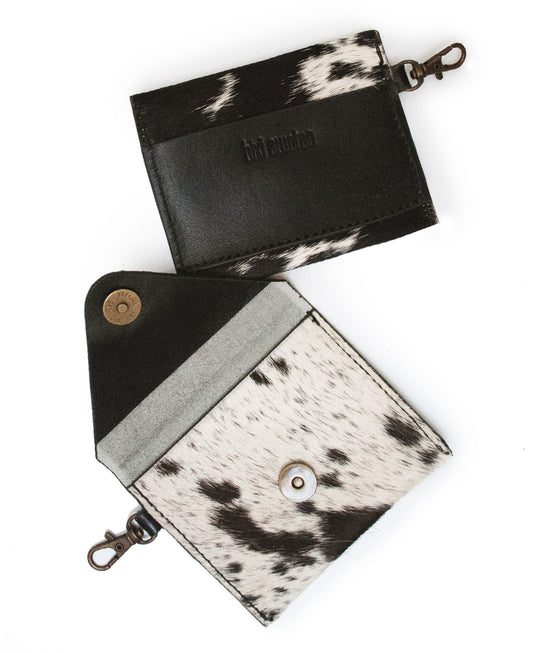 Front view of black and white cowhide fur slim wallet card holder.

Vista frontal de billetera slim piel de vaca con pelo blanco y negro.